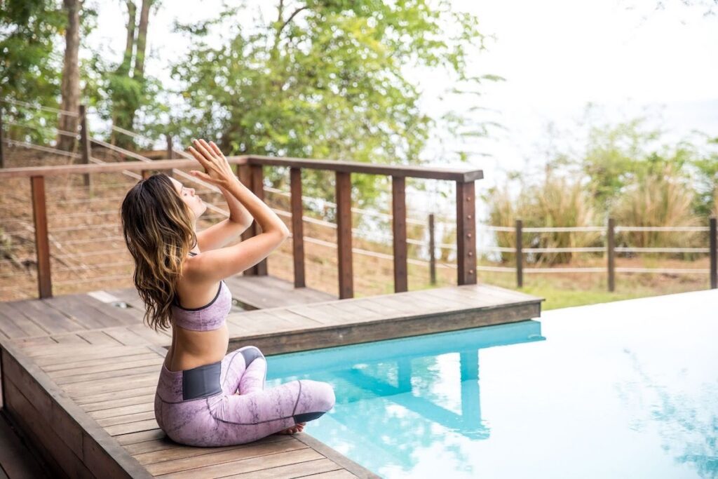 Private in-villa yoga session on a terrace with plunge pool and ocean views at Secret Bay, Dominica.